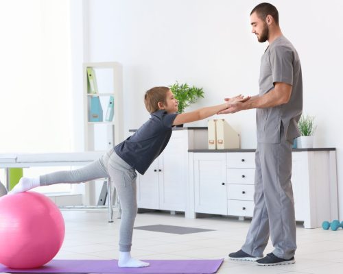 Physiotherapist working with patient in clinic